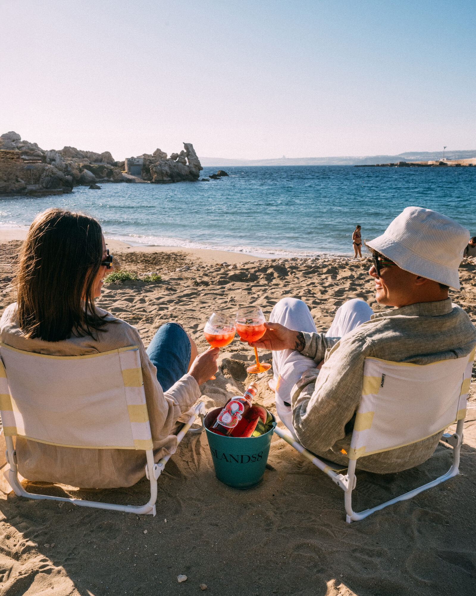 Friends relaxing on a Maltese beach with Islands8